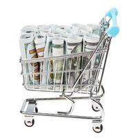 shopping cart with dollar banknotes isolated photo