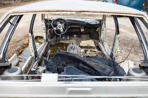 disassembled car at an automobile junkyard photo