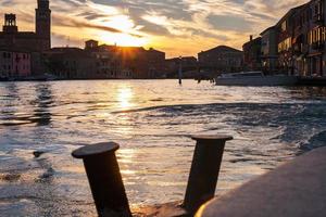 sunset over canal in Venice city photo