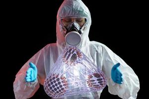 Woman in hazmat suit with anti-virus found for cure Coronavirus disease. Immune vaccine and anti virus concept. photo