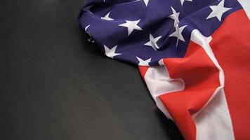 Rumpled Flag of United States of America on grey background. The Star Spangled Banner photo