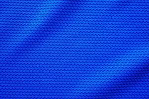 Blue football jersey clothing fabric texture sports wear background, close up top view photo