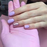 Manicure of different colors on nails. Female manicure on the hand on pink background photo