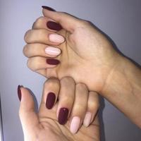 Manicure of different colors on nails. Female manicure on the hand on grey background photo