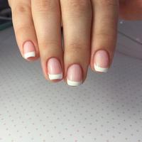 French manicure on the nails. French manicure design. Manicure gel nail polish photo