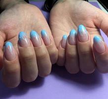 Woman with flesh-colored manicure with design, close up photo