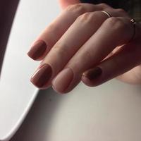 Woman with flesh-colored manicure with design, close up photo