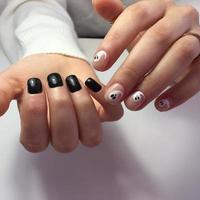 Woman with flesh-colored manicure with design, close up photo