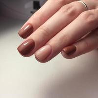 Woman with flesh-colored manicure with design, close up photo