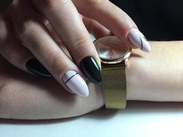 Woman with flesh-colored manicure with design, close up photo