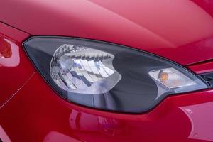 Front side view Headlight of modern red car photo