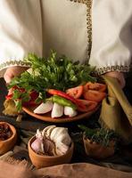 A vertical shot of a waitress presenting a appetizer dish photo