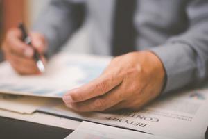 Businessman validates and manages business documents and agreements. , signing a business contract approval of contract documents confirmation or warranty certificate,employment idea, project review photo
