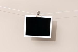 Blank Vintage instant photo frame hanging on a rope. Template