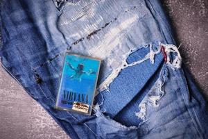 WASHINGTON, USA - September 30 2022  Nirvana's cassette tape and Ripped jeans or Torn jeans. A symbol of the grunge or Seattle sound. photo