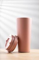 Pastel pink stainless steel tumbler size 20 ounce on wooden table photo