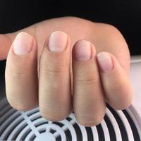 female nails in front of manicure. Female hand after hardware manicure. photo