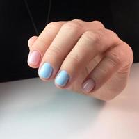 Woman with flesh-colored manicure with design, close up photo