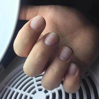 female nails in front of manicure. Female hand after hardware manicure. photo