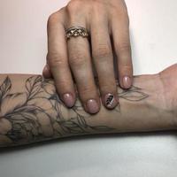 Tattooed hand with manicure photo