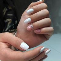 Woman with flesh-colored manicure with design, close up photo