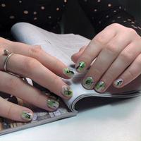 Women's nail manicure on the background of a fashionable glossy magazine photo