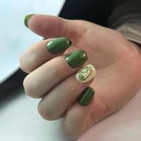 Stylish trendy female green manicure.Hands of a woman with green manicure on nails photo