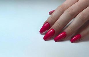 hand with red nails manicure photo