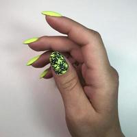stylish design of green manicure on beautiful nails photo
