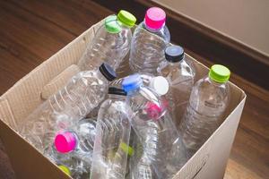 plastic bottles in recycling paper box reuse concept photo