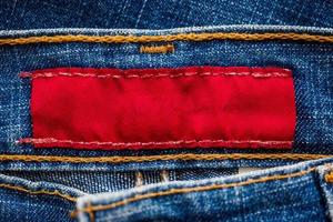 Blue denim jeans with red clothing label photo