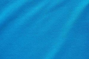 Blue fabric sport clothing football jersey with air mesh texture background photo