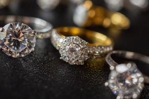 Jewelry diamond rings set on black background close up photo