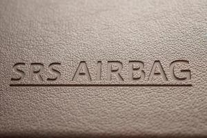 airbag safety sign on brown leather texture in modern car photo