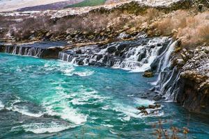 Hraunfossar, a waterfall formed by rivulets streaming over Hallmundarhraun, a lava field from volcano lying under the glacier Langjokull, and pour into the Hvita river, Iceland photo