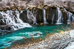 Hraunfossar, a waterfall formed by rivulets streaming over Hallmundarhraun, a lava field from volcano lying under the glacier Langjokull, and pour into the Hvita river, Iceland photo