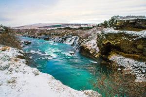Hraunfossar, a waterfall formed by rivulets streaming over Hallmundarhraun, a lava field from volcano lying under the glacier Langjokull, and pour into the Hvita river, Iceland photo