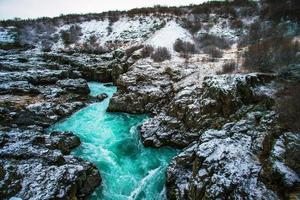 Hraunfossar, a waterfall formed by rivulets streaming over Hallmundarhraun, a lava field from volcano lying under the glacier Langjokull, and pour into the Hvita river, Iceland photo