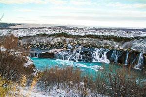 Hraunfossar, a waterfall formed by rivulets streaming over Hallmundarhraun, a lava field from volcano lying under the glacier Langjokull, and pour into the Hvita river, Iceland photo