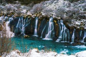 Hraunfossar, a waterfall formed by rivulets streaming over Hallmundarhraun, a lava field from volcano lying under the glacier Langjokull, and pour into the Hvita river, Iceland photo
