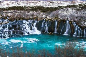 Hraunfossar, a waterfall formed by rivulets streaming over Hallmundarhraun, a lava field from volcano lying under the glacier Langjokull, and pour into the Hvita river, Iceland photo