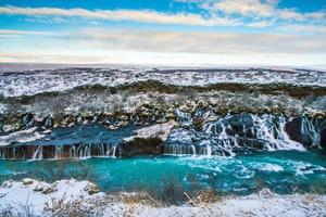 Hraunfossar, a waterfall formed by rivulets streaming over Hallmundarhraun, a lava field from volcano lying under the glacier Langjokull, and pour into the Hvita river, Iceland photo