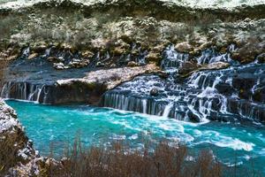 Hraunfossar, a waterfall formed by rivulets streaming over Hallmundarhraun, a lava field from volcano lying under the glacier Langjokull, and pour into the Hvita river, Iceland photo