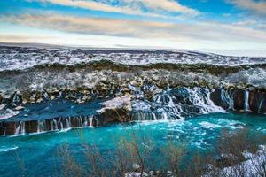 Hraunfossar, a waterfall formed by rivulets streaming over Hallmundarhraun, a lava field from volcano lying under the glacier Langjokull, and pour into the Hvita river, Iceland photo