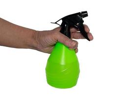 Hand holds a spray bottle. Watering flowers. Gardening, plant care. photo