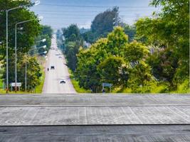 Old wooden table shelf in the background scenery  A highway surrounded by greenery photo