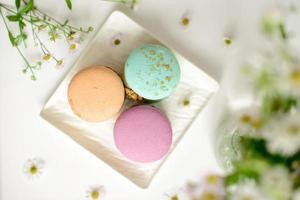 Delicious fresh macaroons with filling on a light wooden background photo