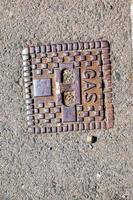 Manhole cover of the gas pipeline system. A massive metal hatch for access to city communications in the pavement. photo