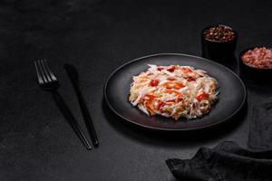 A delicious fresh vegetarian salad of white cabbage, carrot and paprika photo