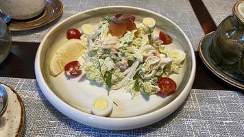 A large plate with seafood salad on the table photo